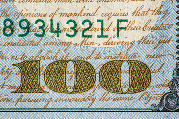 Fragment of a banknote of 100 dollars. Photographed close-up.