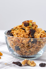 Homemade granola cereal in glass bowl, healthy eating concept