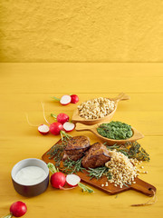 Grilled meat with cooked barley and salsa verde