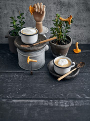 Mushroom cream soup with whiped cream served in glazed steel cups