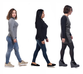 Obraz premium group of women waling on white background, side view