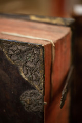 Large old leather book with metal corners and lock. Shallow depth of field.