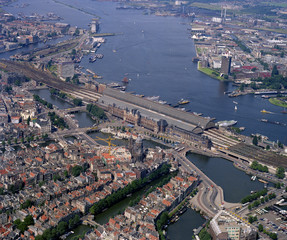 Amsterdam, Holland, August 24 - 1987: Historical aerial photo of the Central Station and IJ in the center of Amsterdam