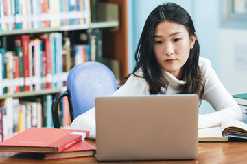 Young beautiful asian student study or work at home and using laptop for online learning.e-Learning education concept.Back to school