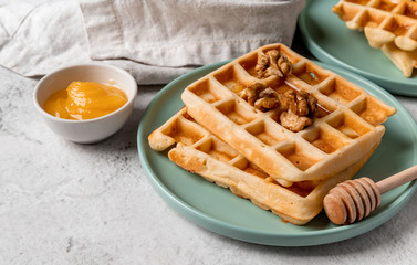 Sweet homemade waffles with walnuts and honey