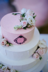Fototapeta na wymiar three-level wedding cake decorated with rose flowers