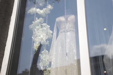 wedding dresses displayed in window showcase