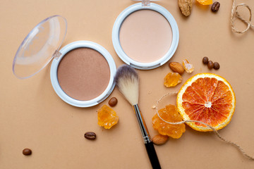 Obraz na płótnie Canvas Cosmetics for natural makeup, highlighter powder and toner, fluffy makeup brush on top.