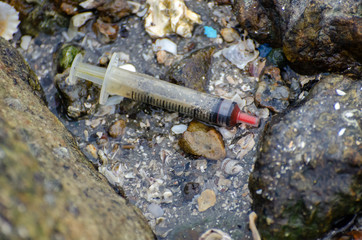 Needle syringe as rubbish at coastal.