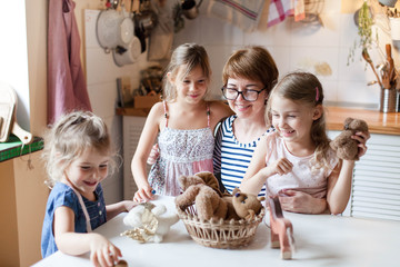 Happy family stay home. Kids playing in puppet show. Mother and children together have fun and game with toys. Leisure without gadgets. Lifestyle authentic moment. Social distancing, self isolation.