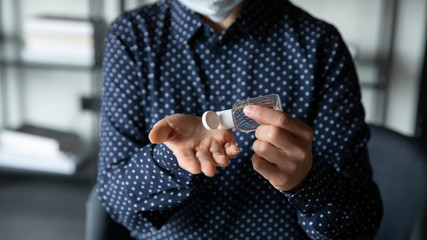 Close up focus on young indian ethnic woman applying antiseptic gel from plastic bottle on hands, doing healthcare hygienic routine, preventing covid 19 corona virus outspread, quarantine measures.
