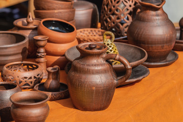 Fototapeta na wymiar Ancient clay kitchen utensils. Selective focus.