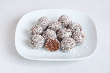Homemade raw chocolate energy balls with dates, almond and coconut flakes.  Selective focus