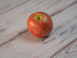 Red apple on the old wooden table