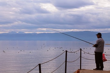 man fishing on the pier