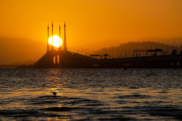 Naklejka premium Egg yolk sun trapped in cable stayed Penang Bridge.