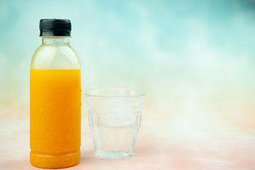 Close up of plastic bottles with fresh orange juice