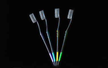 set of multi-colored toothbrushes on a black background