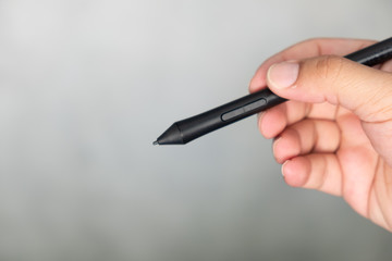 Hand holding black smart pen