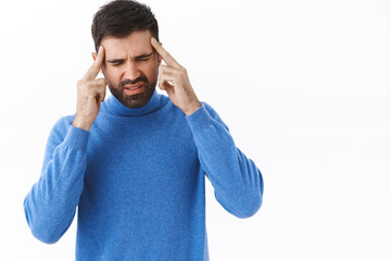 Portrait of male employee, bearded guy close eyes and grimacing from painful ache in temples, suffering headache or migraine, feeling sick, caught fever, need painkillers, white background