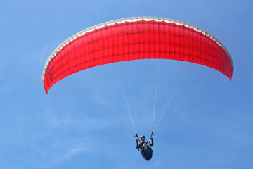 Paraglider flying wing in a blue sky	