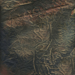 Old crumpled paper background with dirty grunge texture and abstract rough peeling. Grunge textured backdrop.