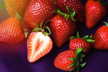 Top of view fresh strawberry on colorful purple background.