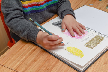 Child learning at home. Pre school age child learning about shapes and hand writing