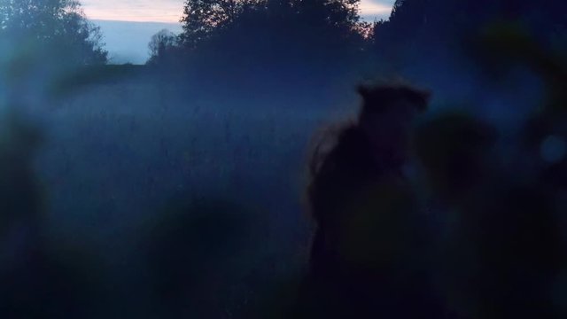 Witchy Young Woman Runs At Dusk, View Through Tree Branch