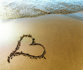 Beach. Heart painted on sea sand