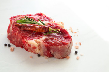 Tasty fresh beef steaks on light background