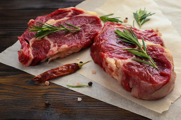 Fresh beef steaks on wooden table