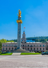 Fototapeta na wymiar Freedom and Victory Square with the Freedom Monument showing St George Statue in a central column. Tbilisi City Hall behind. Located in Shota Rustaveli Avenue.