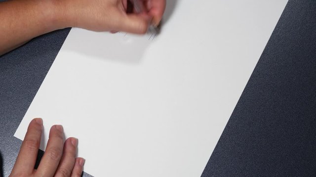 Counting the days drawing lines with diagonal slash isolation time concept. Female with pen, hand draws parallel tally marks on a white paper and writes counting the days message.