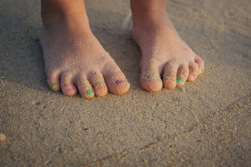 Fototapeta na wymiar Baby legs on the sand beach