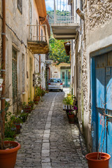 Fototapeta na wymiar Cyprus village Lefkara. View of a narrow village stony street with lot of green and flower pots