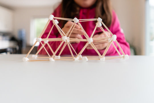 Closeup of a three dimensional pyramid built with toothpicks and marshmallows for a homeschool STEM project