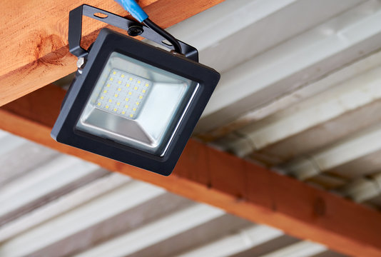 LED flood light, spot light on the top of the roof. Powerful construction lighting floodlight a lantern for illumination of a local area at night