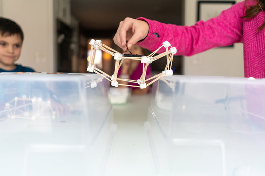 Children testing a suspension bridge of out marshmallows and toothpicks for a STEAM lesson