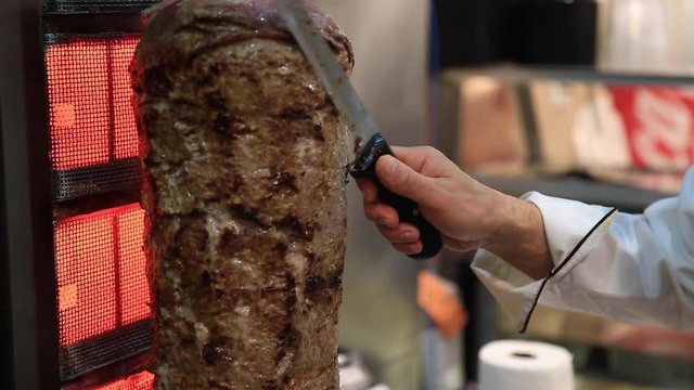 Cutting gyro in fast food restaurant 
