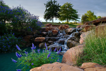 A pretty park in Frisco, Texas with a running waterfall.