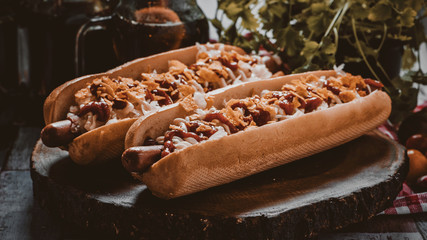 Two hot dogs closeup with ingredients. - obrazy, fototapety, plakaty