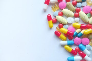 Assorted medical drugs and capsule on white background 