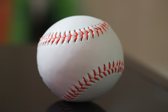 Closeup image of baseball with red stitching