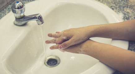 Young women wash their hands with soap to prevent bacterial and viral infections Corona or Covid-19, Inhibiting the spread and protection of the virus concept..