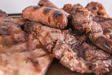 Barbecue of varied meats with chorizo criollo, chicken and veal chops served on a hot stone.
