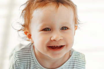 little girl 1-2 years old smiling and looking at the camera