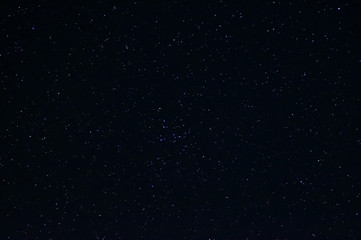 Long exposure night photo of a bright stars. A lot of stars with constellations. Far from the city. Night landscape.
