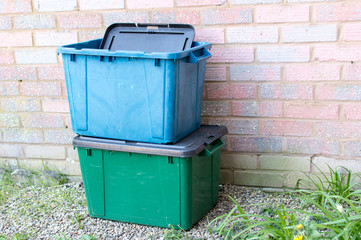 A green and blue recycling box outside a property in UK