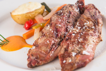 Grilled pork tenderloin with baked potato and vegetables.